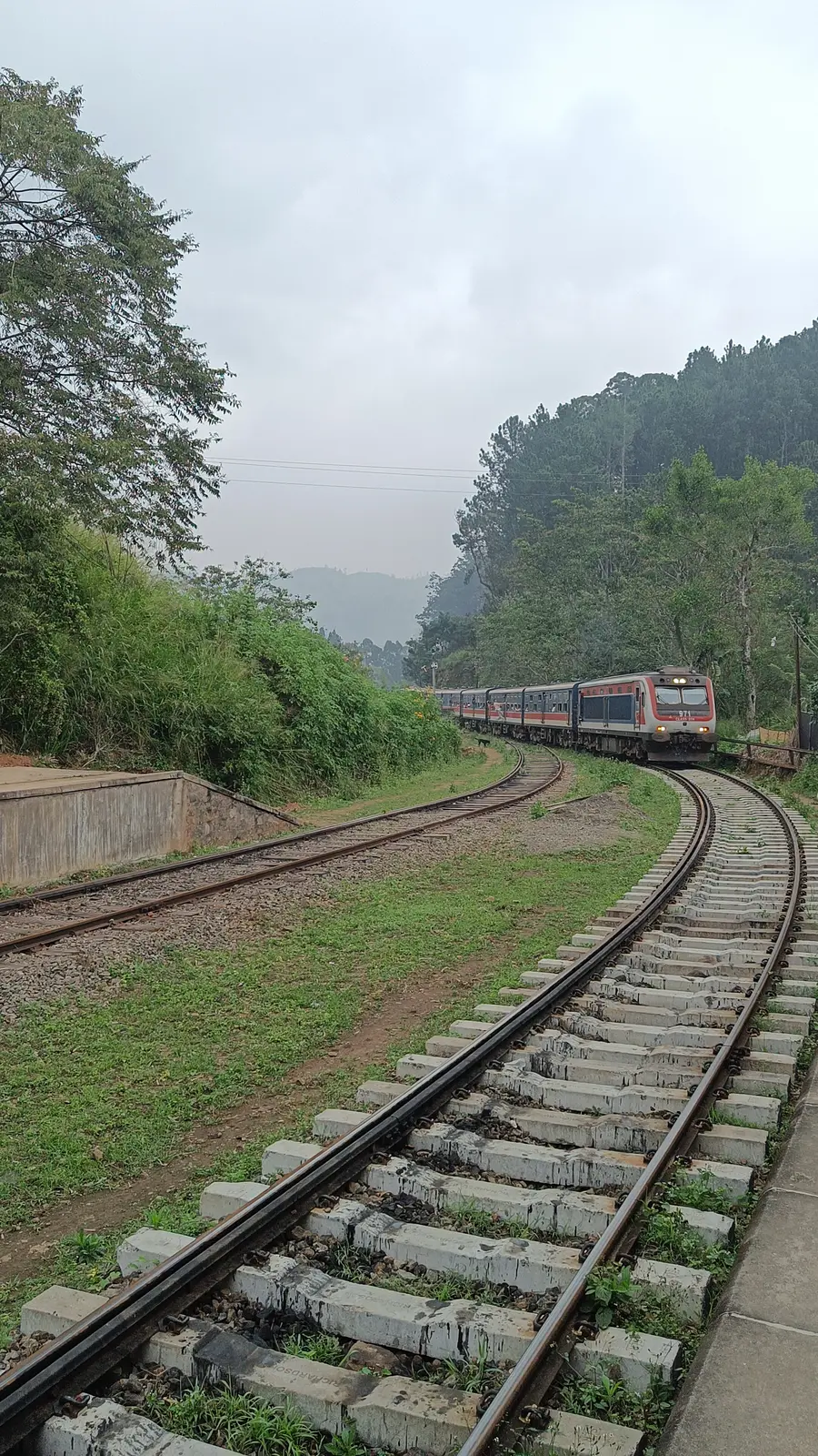 Railway tracks winding through Sri Lanka's misty hill country